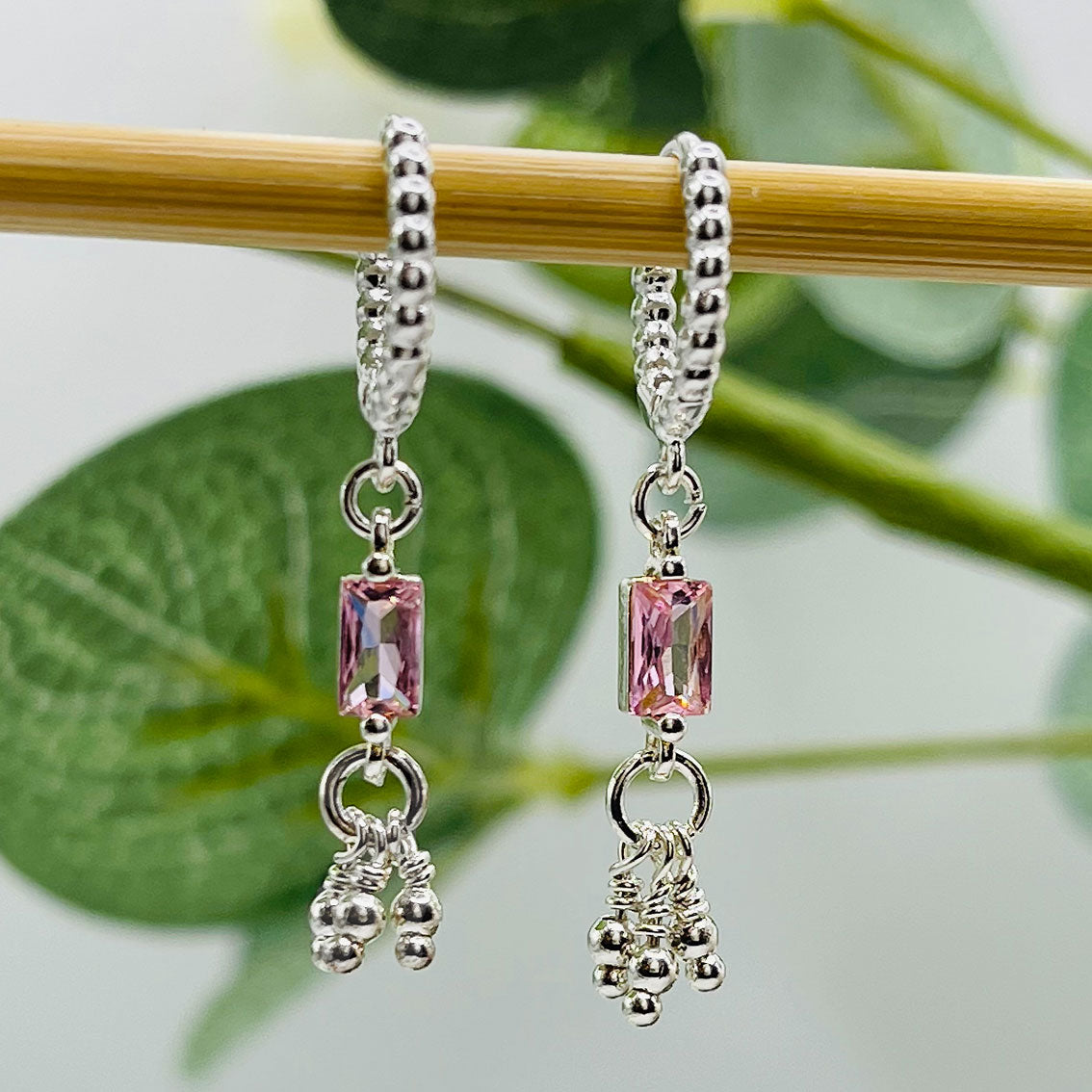 Kleine Silbercreolen mit verspielten Anhängern und rosa Kristall